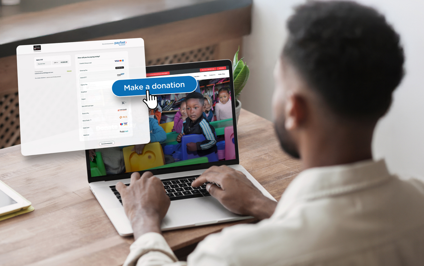 A man making an online donation on his computer to Ladles of Love